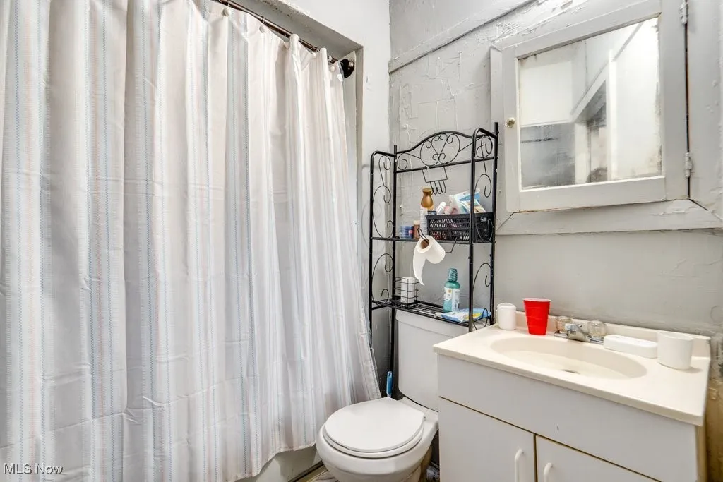 Full bathroom featuring vanity and shower / bath combination with curtain