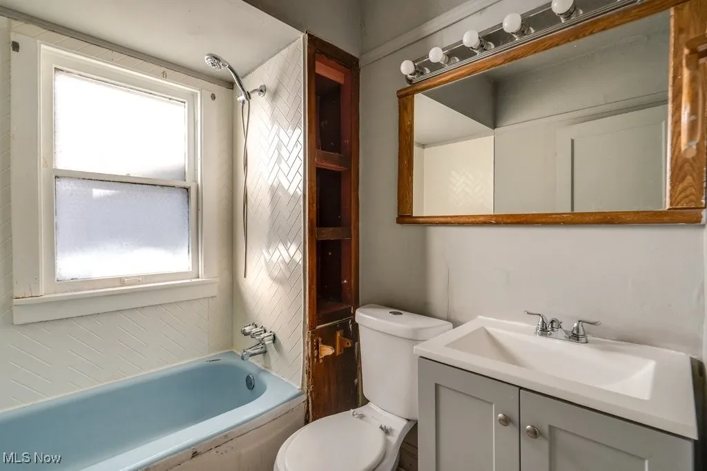 Bathroom with vanity and bathtub / shower combination
