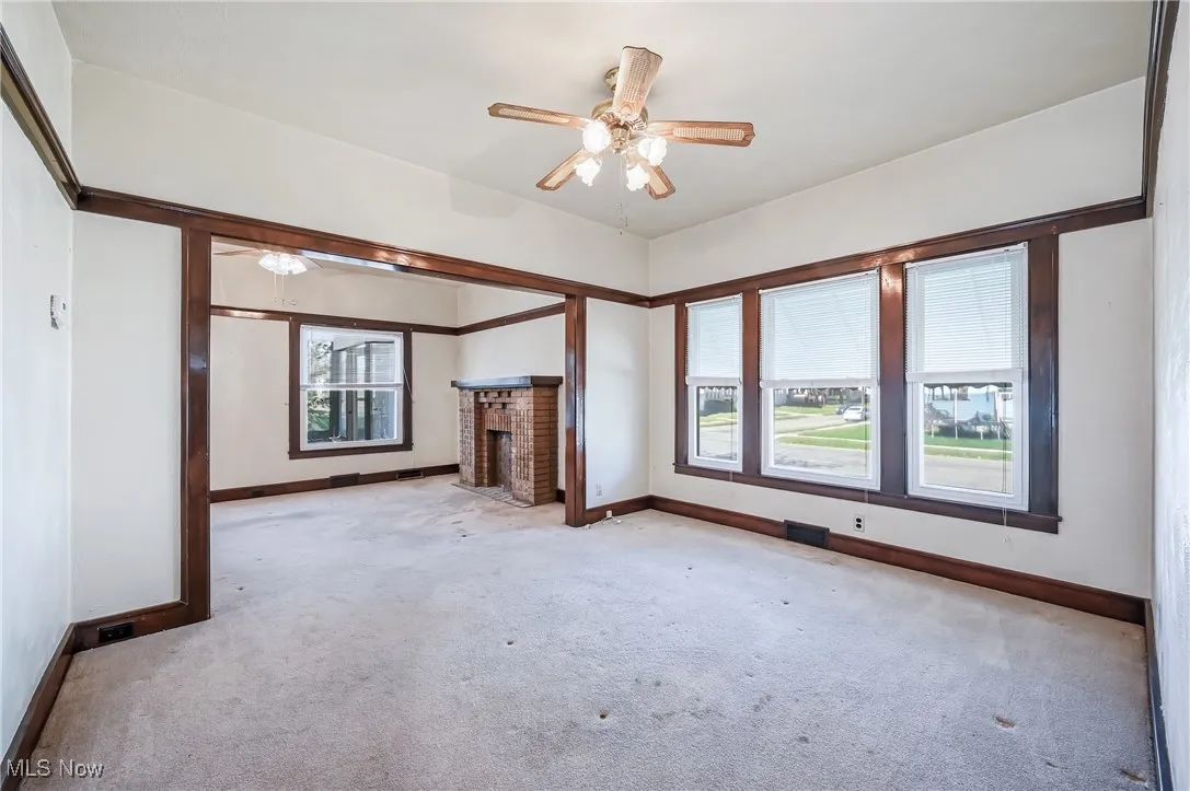 Large dining room with a trio of vinyl windows and ceiling fan