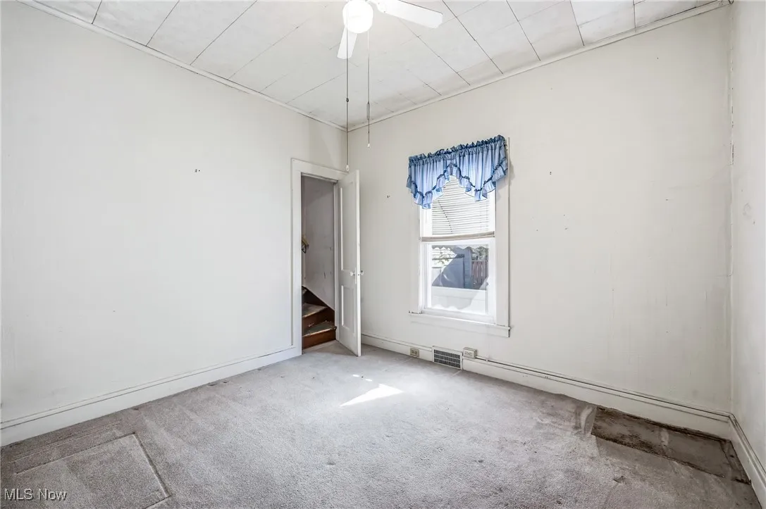 Bedroom without closet featuring baseboards and a ceiling fan