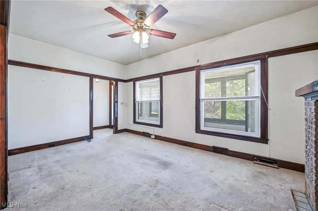 Large living room brick fireplace used for decoration only... has a gas line but the opening is closed off with brick.. Vinyl windows and ceiling fan