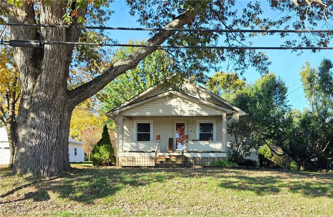 View of front of home featuring covered porch and a front lawn