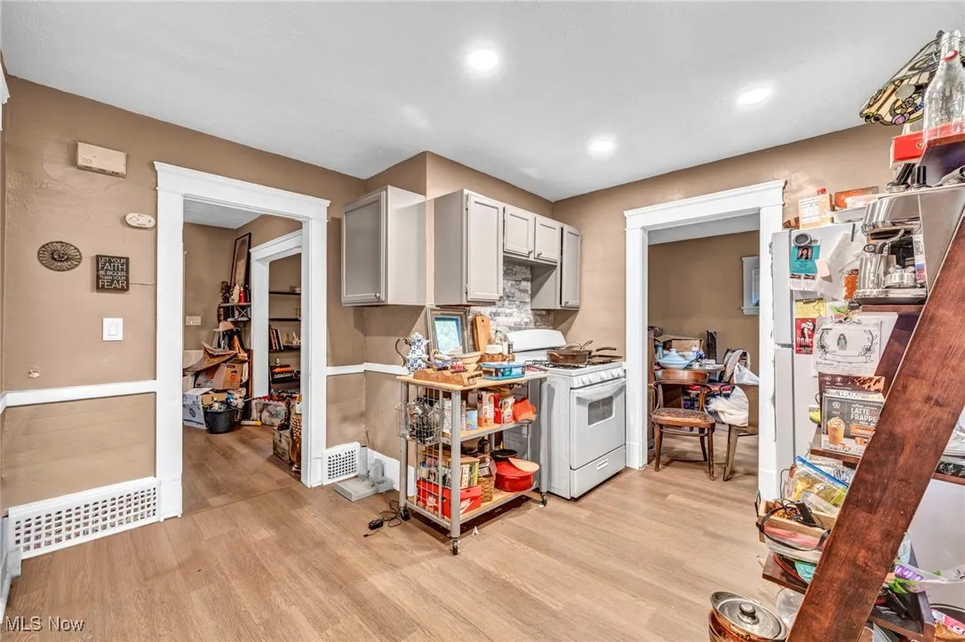 Kitchen featuring gray cabinetry, white appliances, light wood-style floors, light countertops, and recessed lighting
