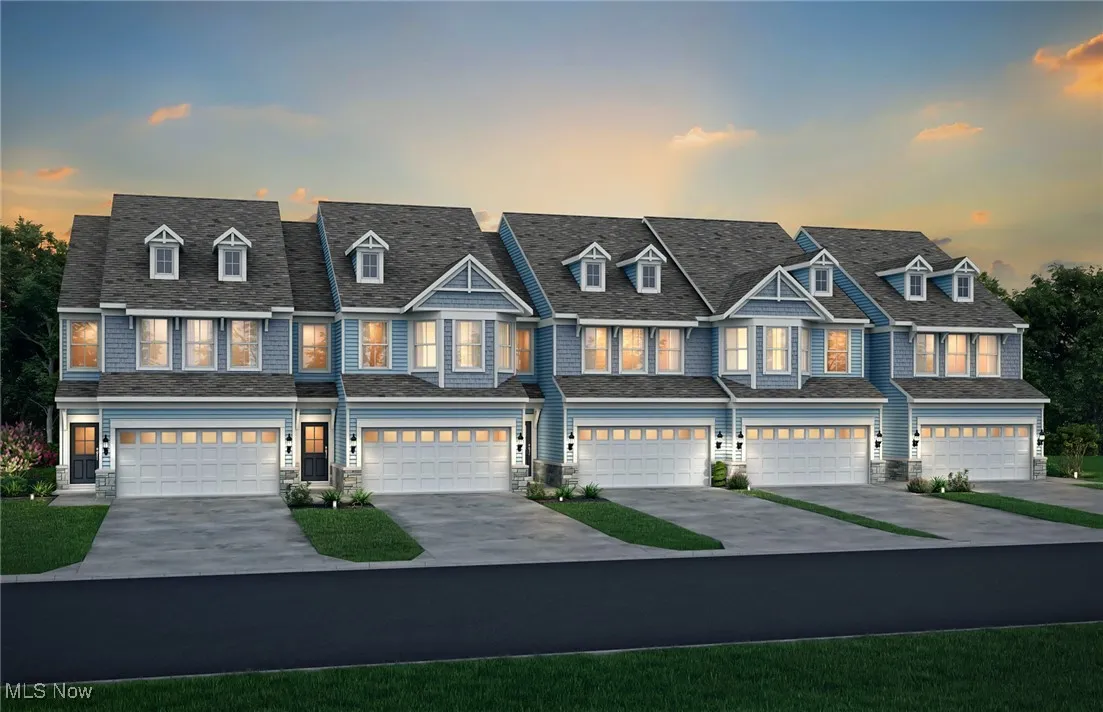 View of front facade with driveway and an attached garage