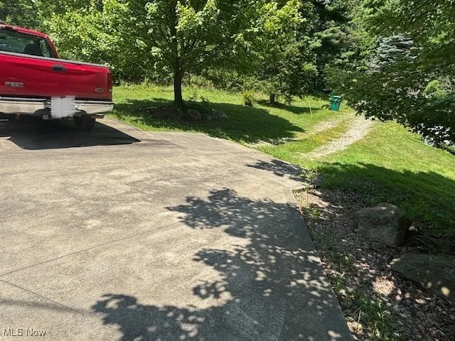 Driveway parking is NOT part of this property, meant to show where current road ends. Need to make your own driveway