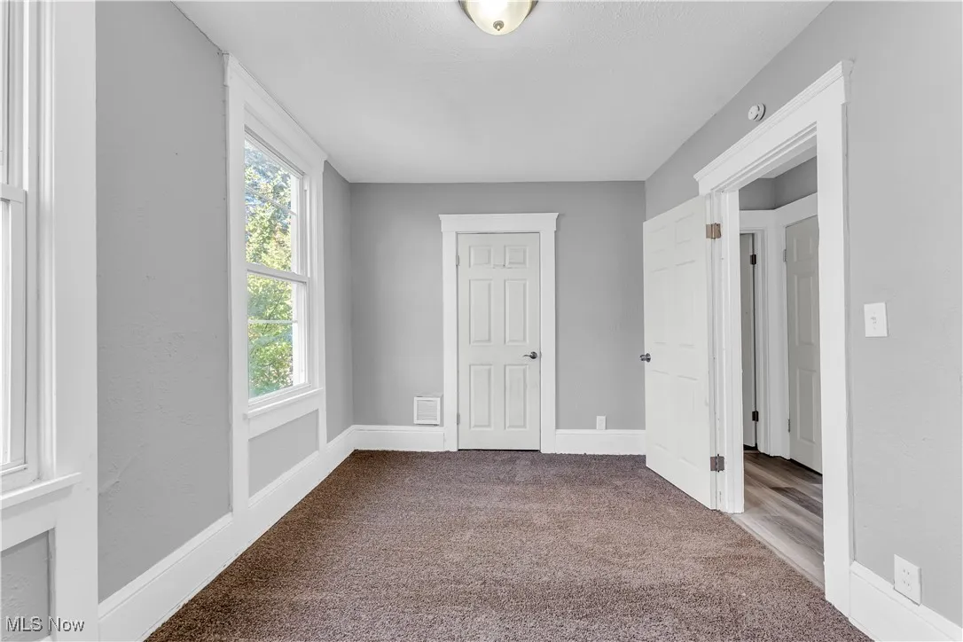 Unfurnished bedroom featuring carpet and baseboards