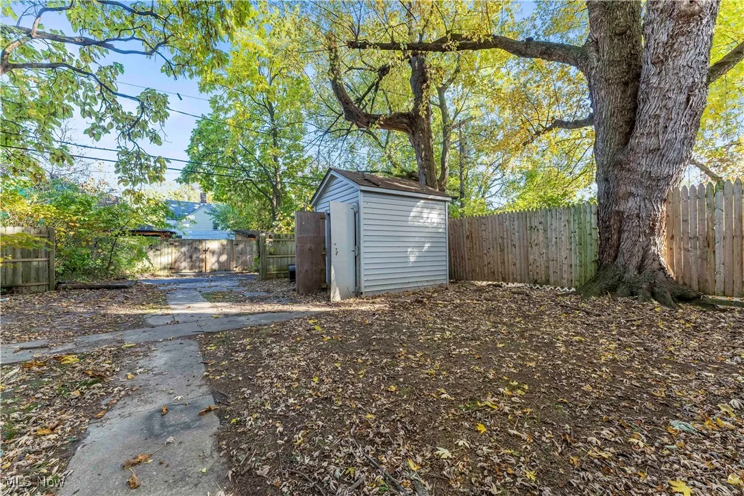 Fenced backyard with a storage unit