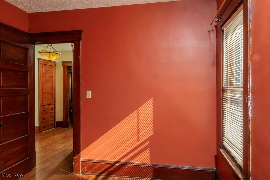 Bedroom with dark wood-style flooring and a textured ceiling