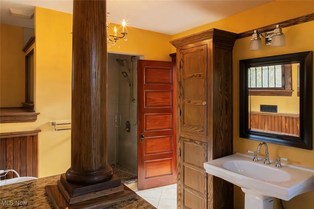 Full bathroom with a shower stall and light tile patterned floors