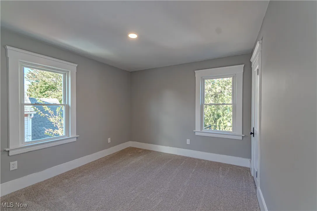 Spare room featuring light carpet and recessed lighting
