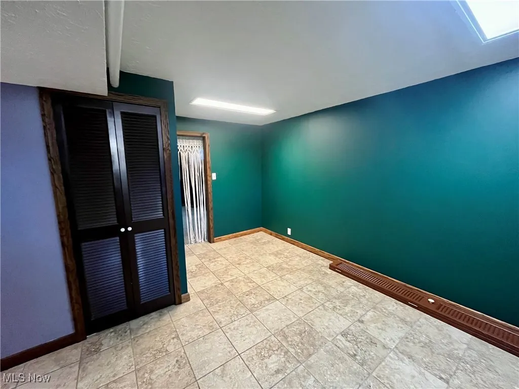 Unfurnished room featuring baseboards