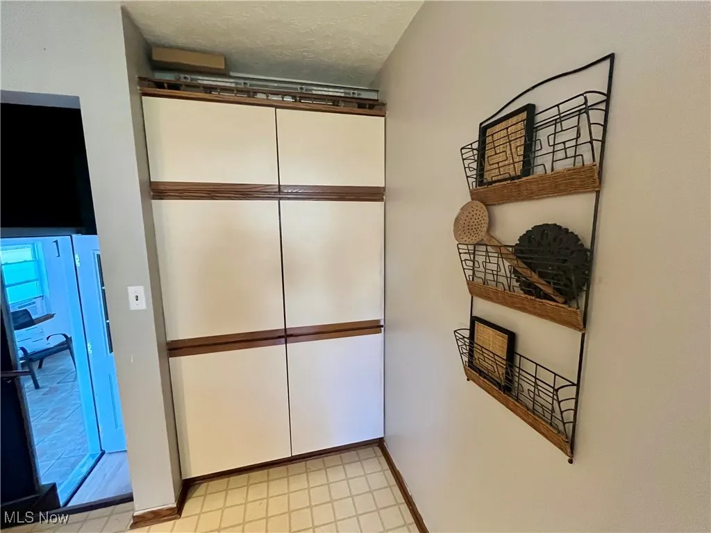 Detailed view of a textured ceiling and baseboards