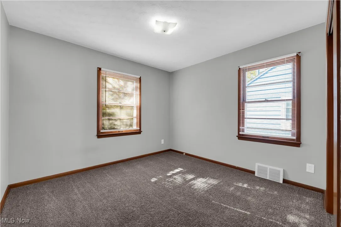 Carpeted empty room with healthy amount of natural light