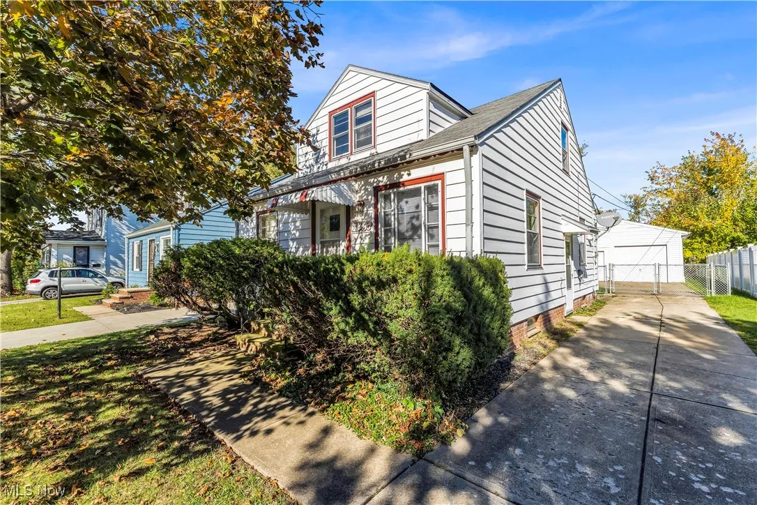 View of front of house featuring a garage and roof with shingles