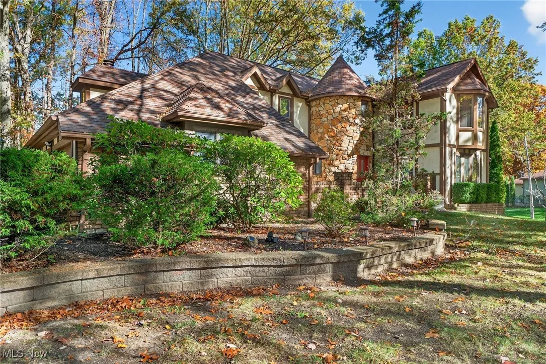 English style home featuring stucco siding