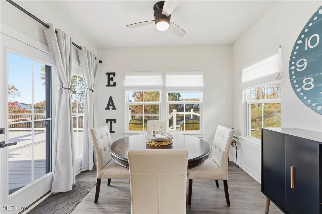 Dining area featuring wood finished floors and a ceiling fan