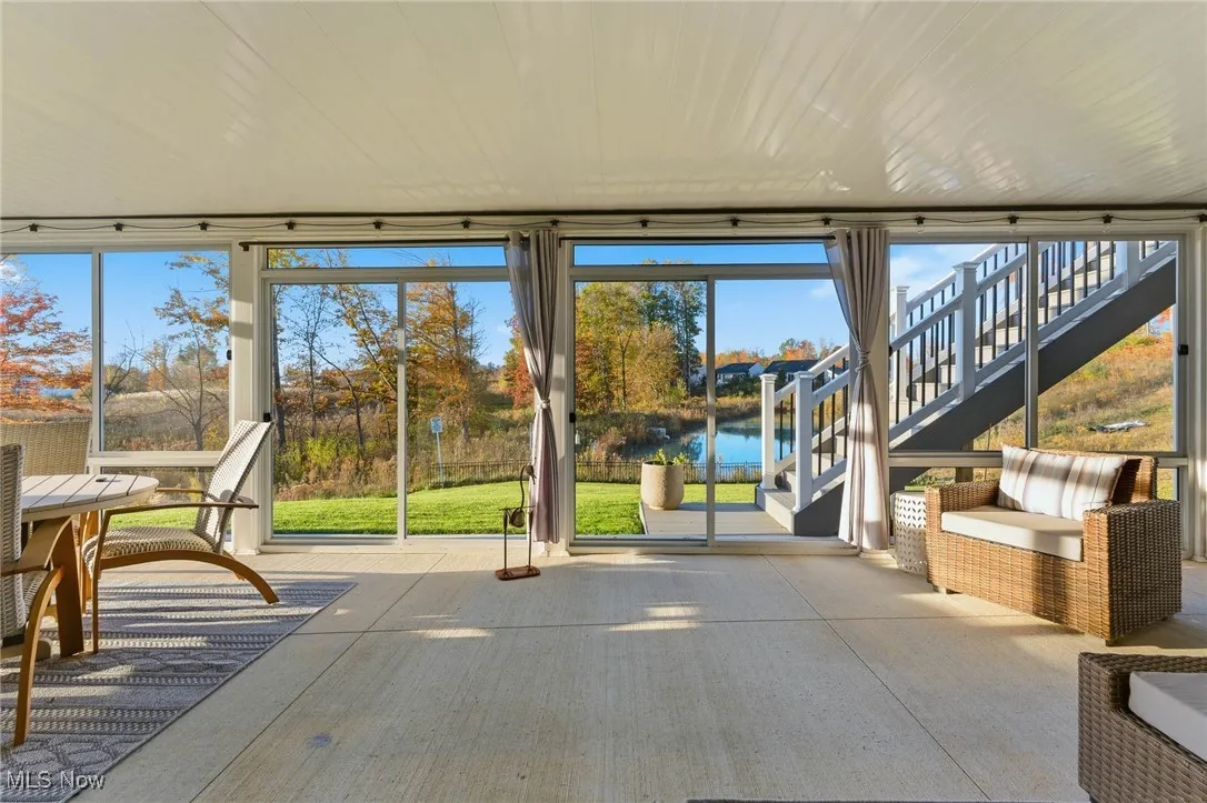 Covered/screened patio with a water view and a wall of windows