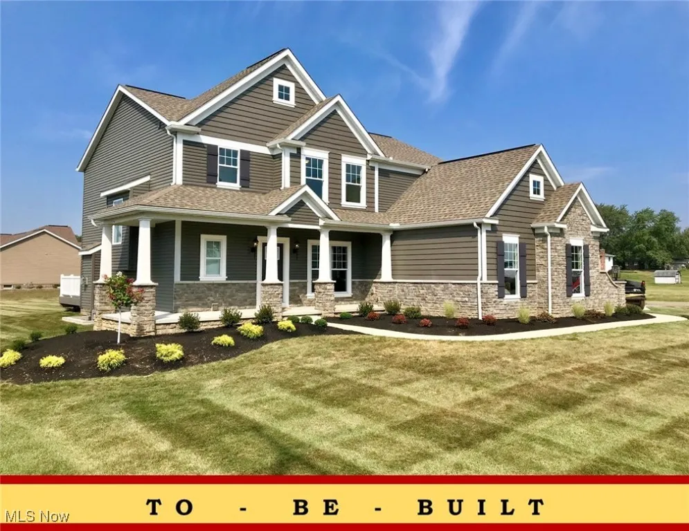 Craftsman inspired home featuring stone siding, covered porch, a shingled roof, and a front yard