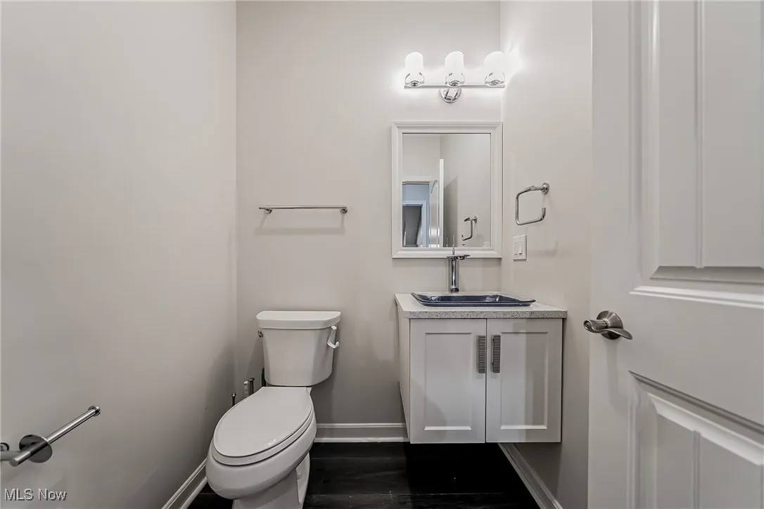 1st floor 1/2 Powder room featuring vanity w/glass bowl sink and dark wood-style floors
