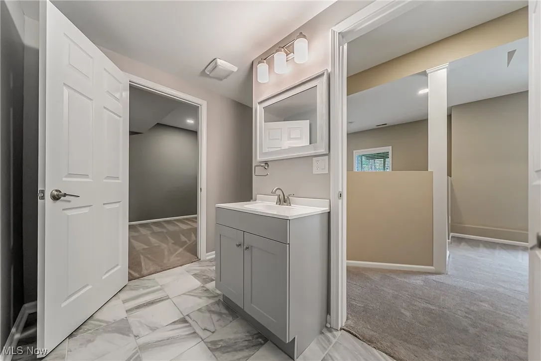 Walk-out basement 1/2 1/2 bathroom with view to main living areas and bonus room