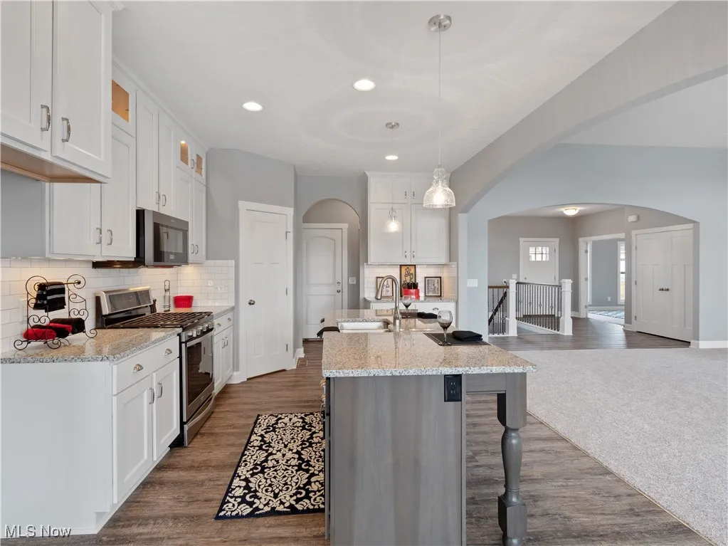 Kitchen island with electrical outlets, double sinks and dishwasher