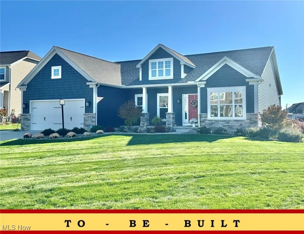 Craftsman-style house with stone siding, a porch, a front yard, and roof with shingles