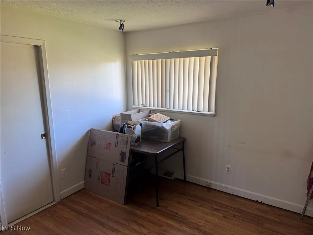 Office space featuring wood finished floors and a textured ceiling