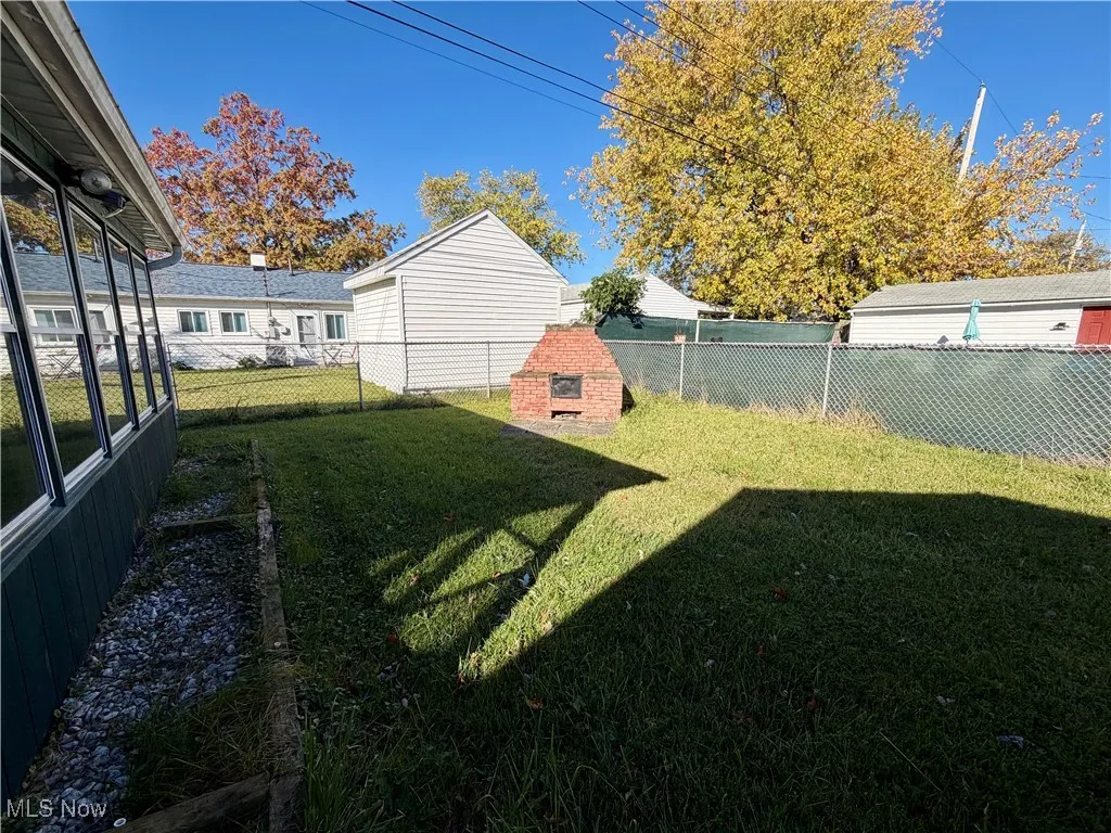 Fenced backyard with a sunroom