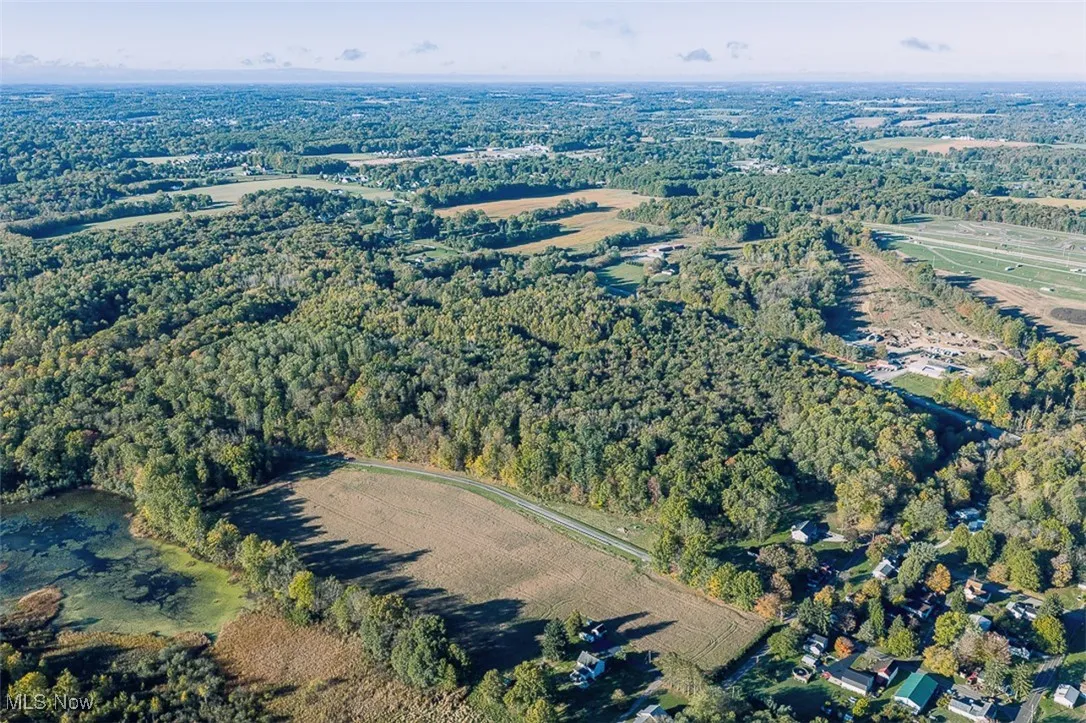 Aerial overview of property's location featuring a heavily wooded area