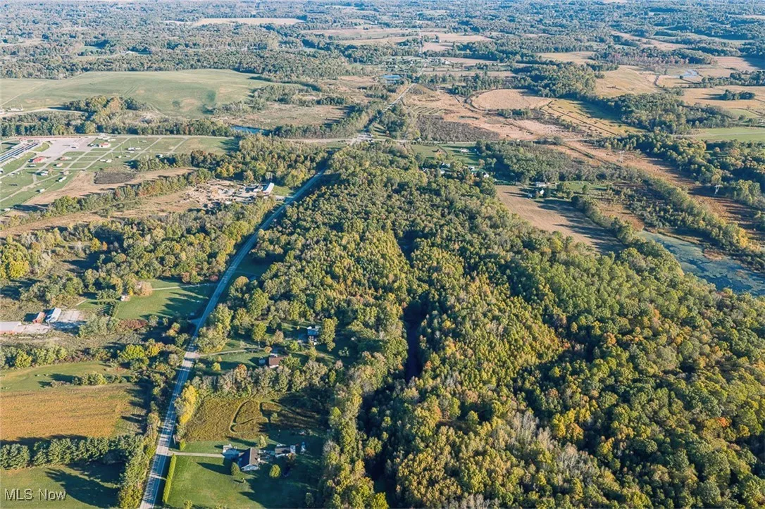 Aerial view of property's location featuring a forest