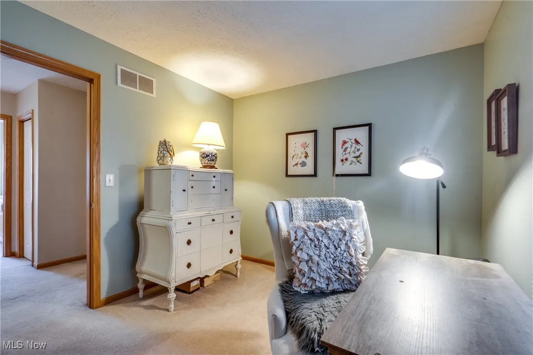 Bedroom featuring carpet flooring and baseboards