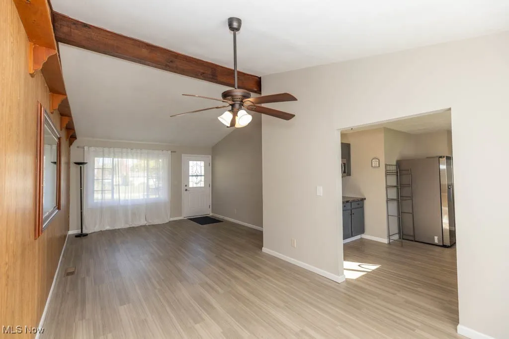 Unfurnished living room with light wood-style floors and ceiling fan
