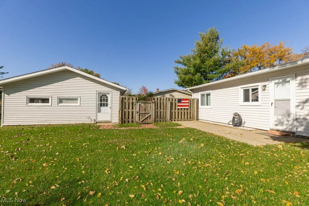 Rear view of property featuring a gate and a patio