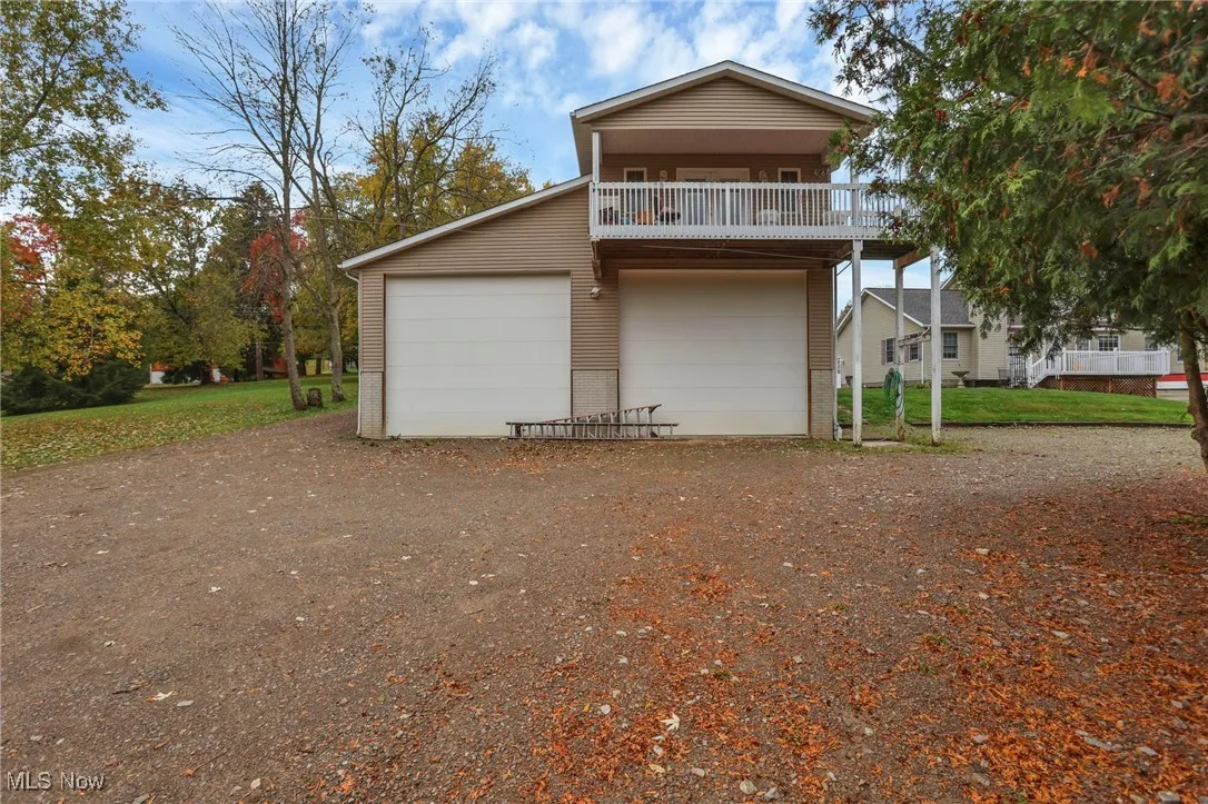 View of front of property with a garage, driveway, brick siding, and a front lawn