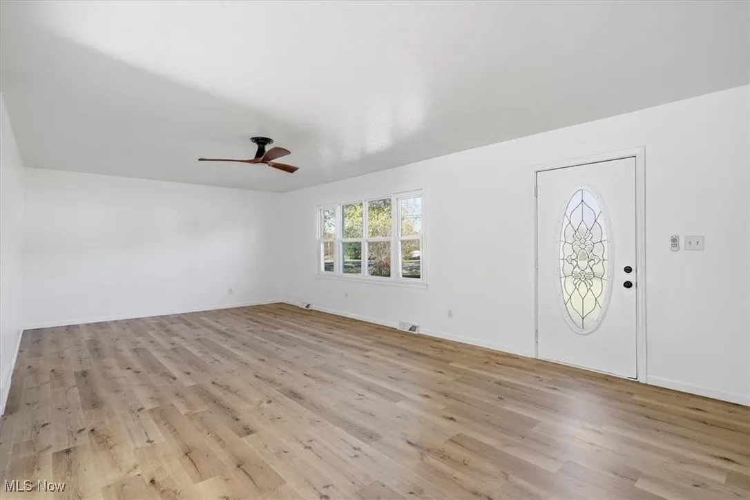 Foyer entrance featuring light wood-type flooring and ceiling fan