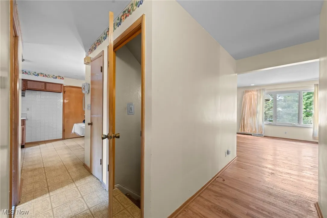 Corridor featuring baseboards and light floors