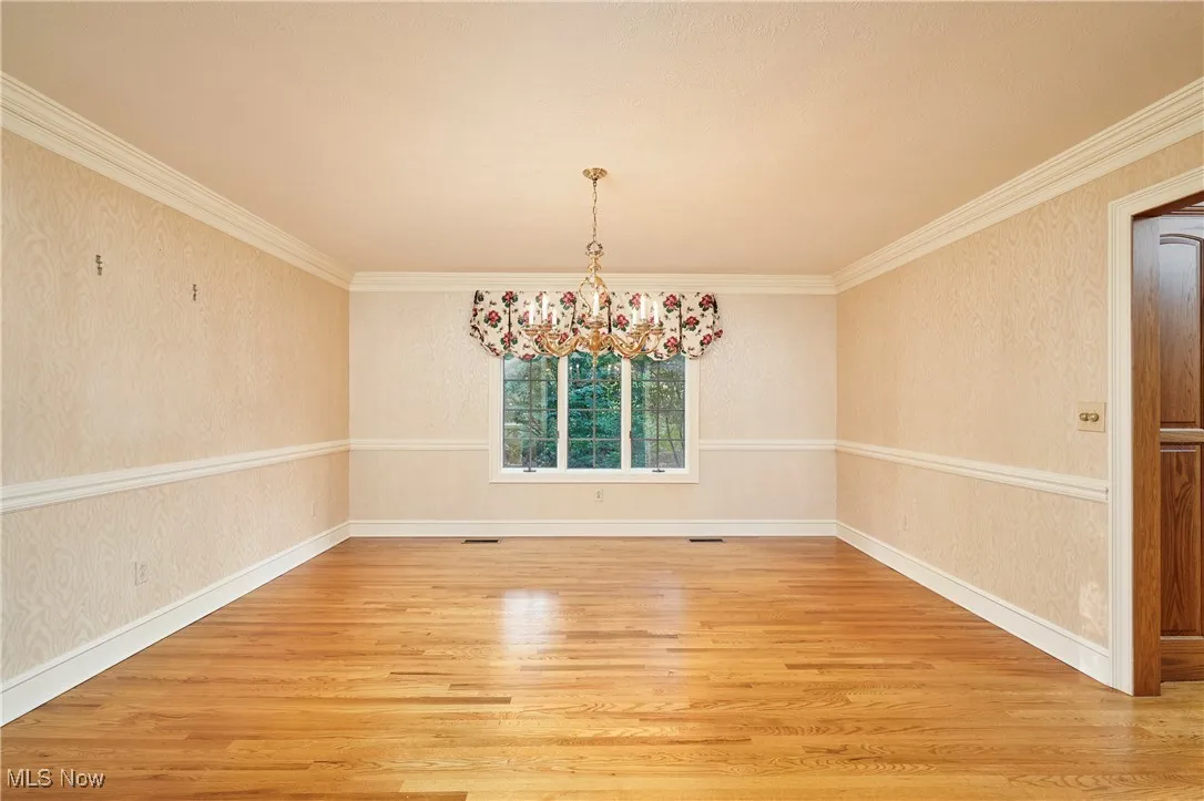 Dining Room with wood floors and lovely chandelier and sconces (not pictured)