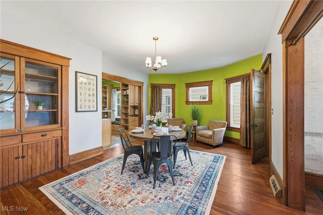 Dining space featuring a chandelier and dark wood-style floors