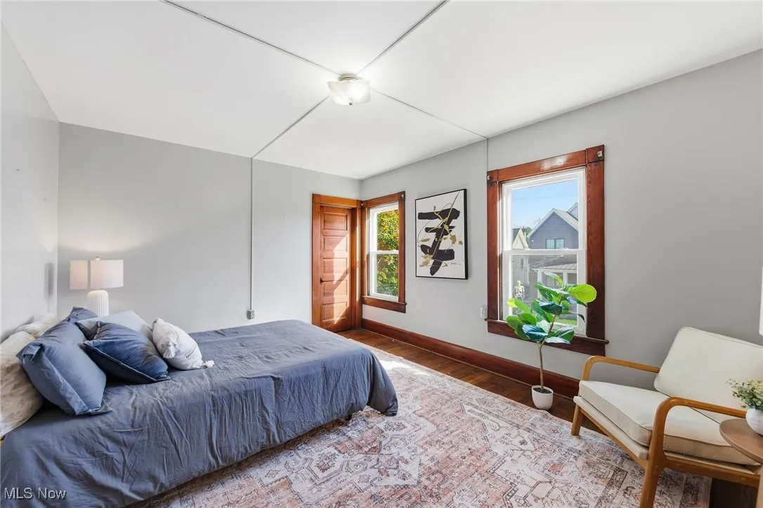 Bedroom with wood finished floors and baseboards