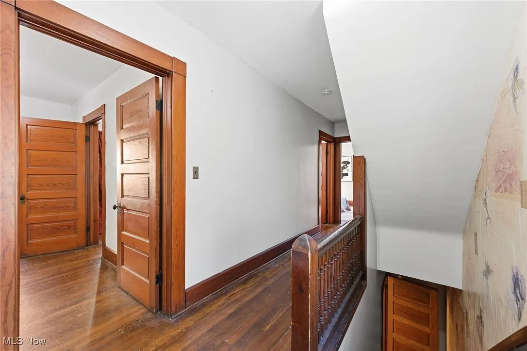 Corridor featuring an upstairs landing and hardwood / wood-style flooring