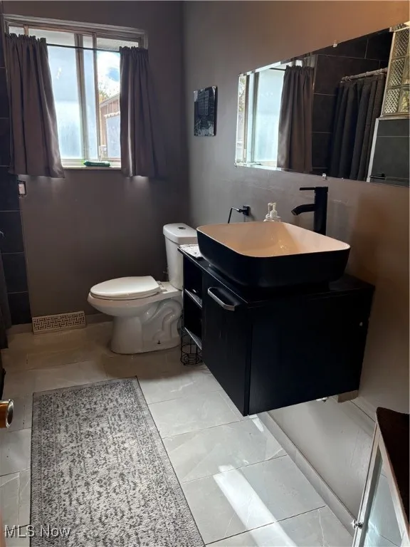 Full bathroom with vanity and curtained shower