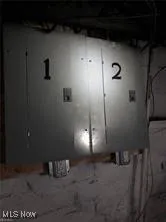 Unfinished below grade area with electric panel