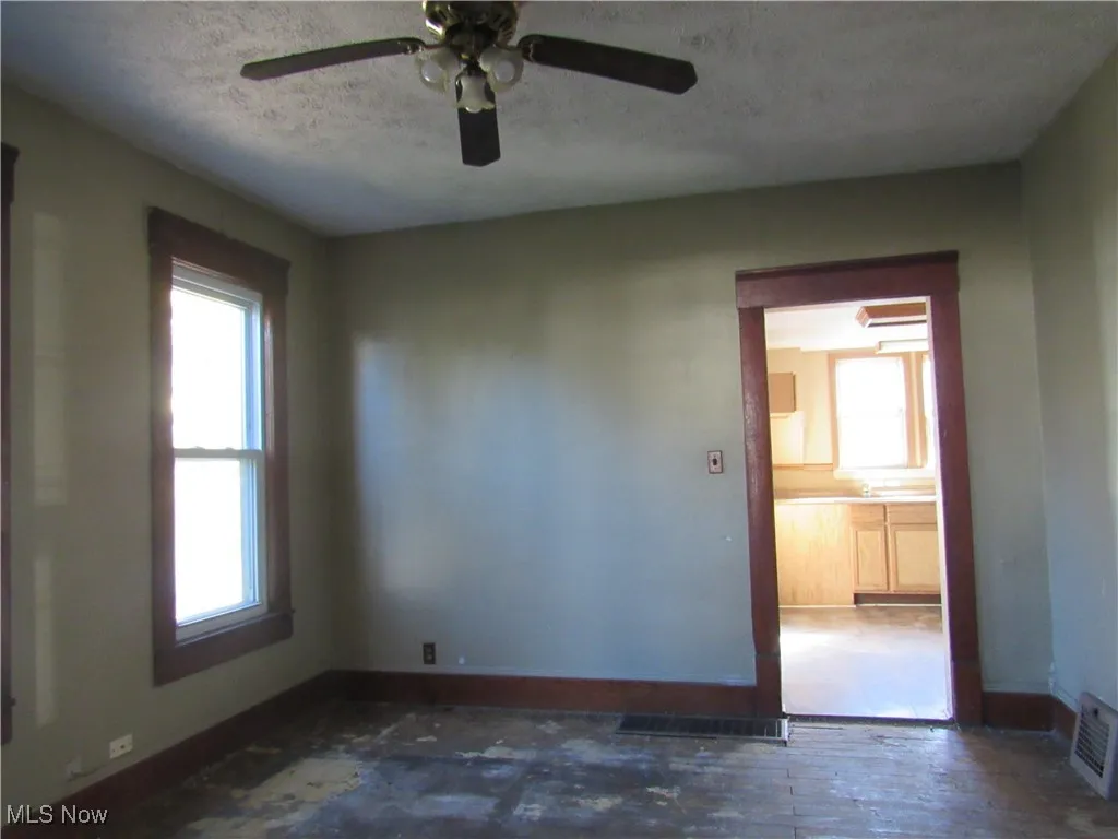 Spare room featuring a textured ceiling and baseboards