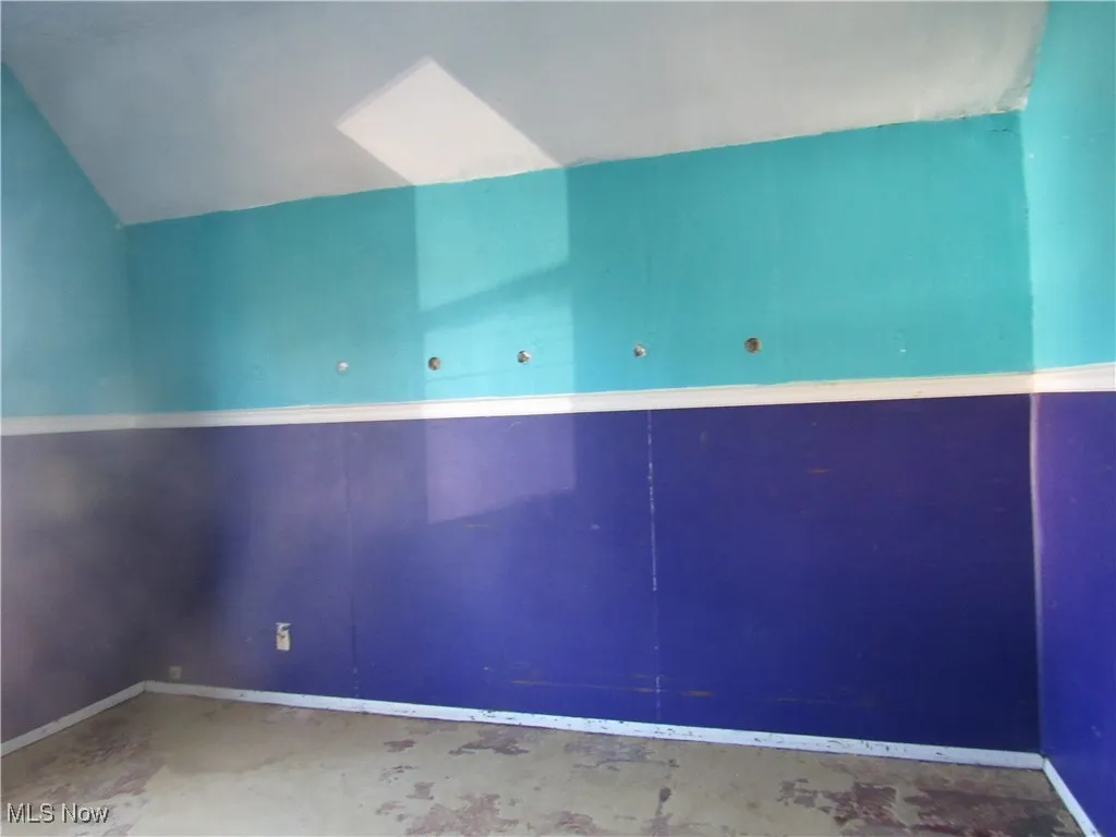 Additional living space featuring a skylight and lofted ceiling