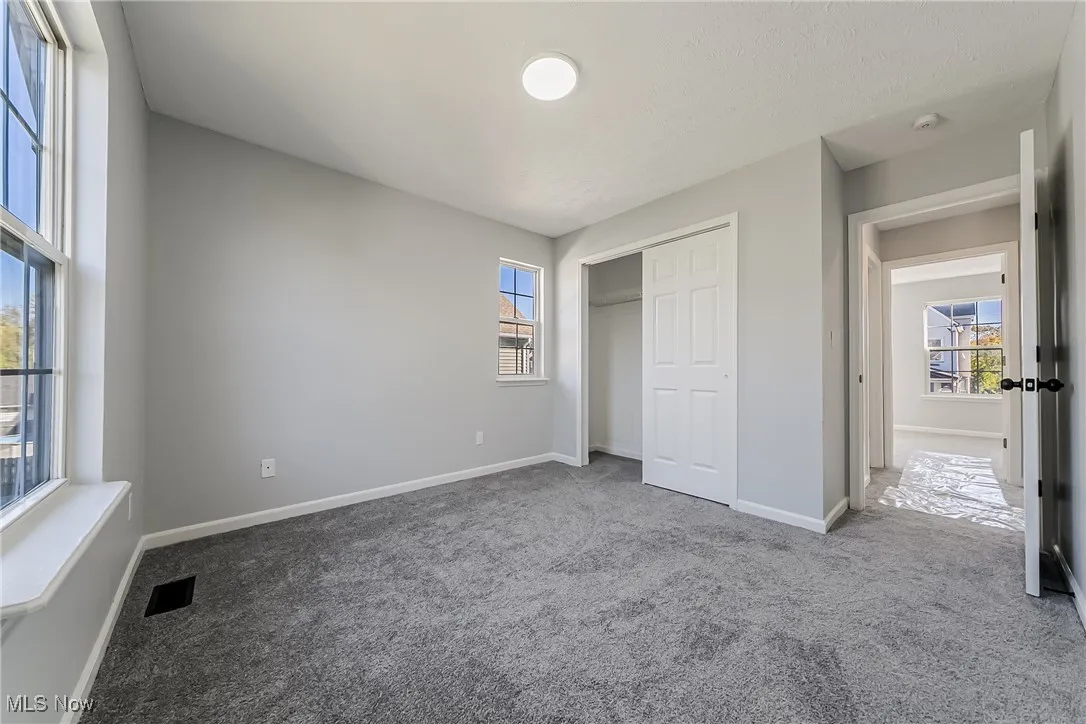 Unfurnished bedroom featuring carpet and a closet