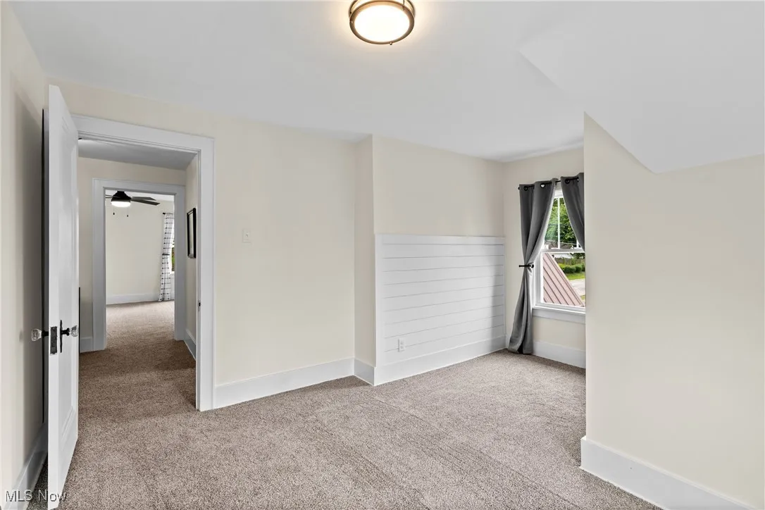 Unfurnished room featuring light colored carpet