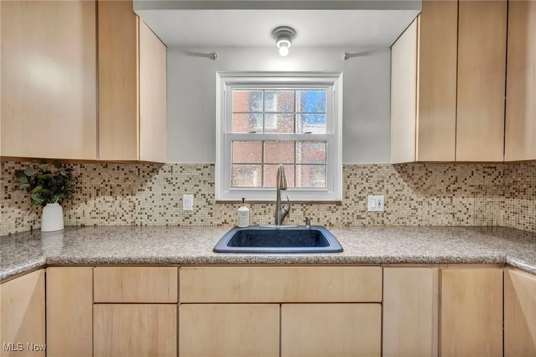 Kitchen featuring maple cabinets and backsplash