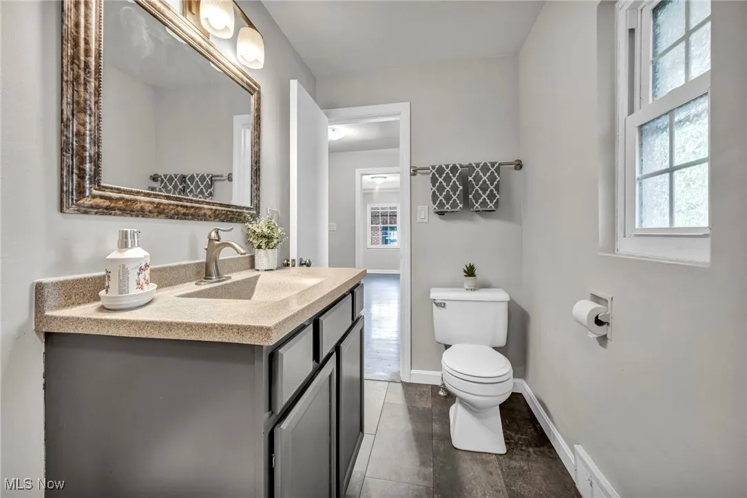 Full bathroom featuring vanity and baseboards