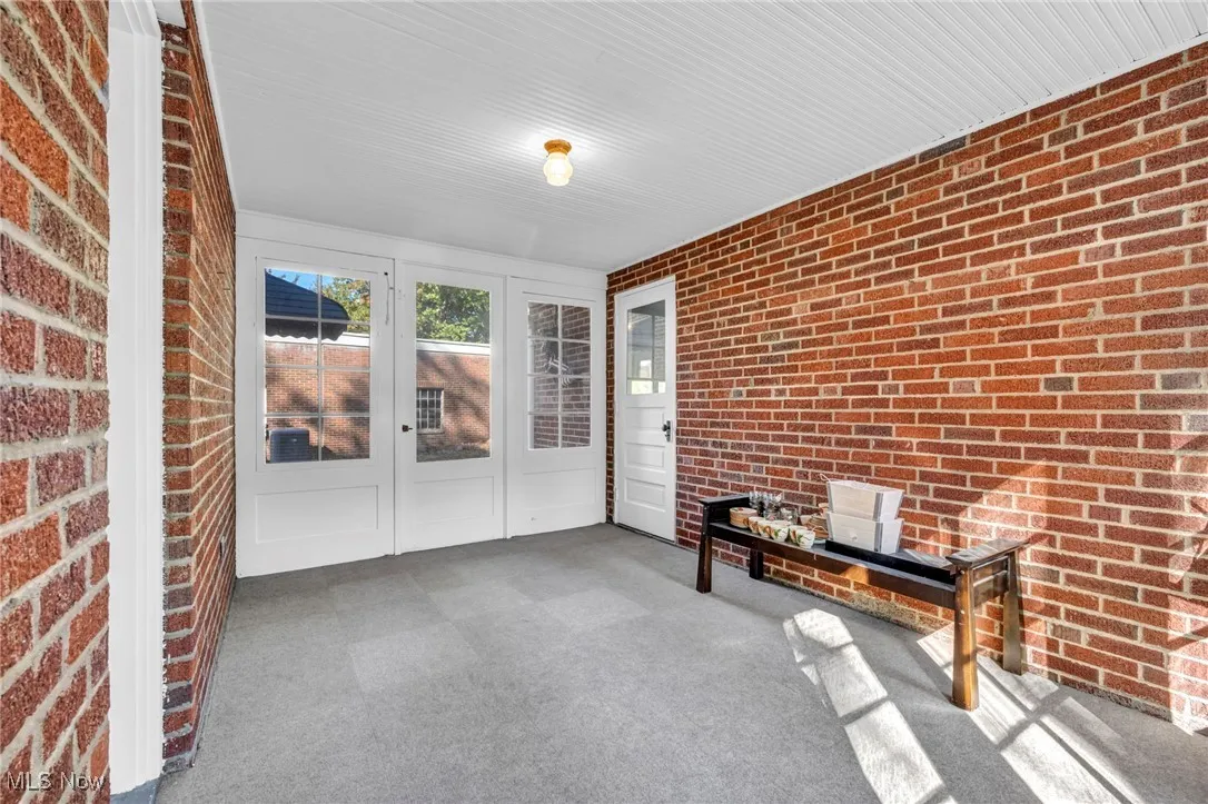 Sunroom / solarium featuring french doors