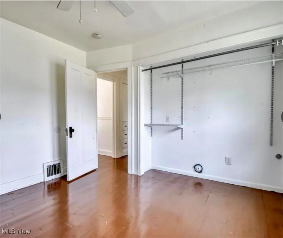 Unfurnished bedroom with wood finished floors and ceiling fan